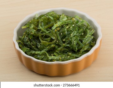 Chuka salad with sesame seeds on the wood background - Shutterstock ID 273666491