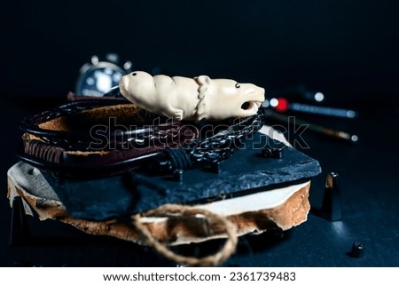 Chukchi walrus tusk amulet in the shape of bear and seal heads