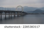 Chuncheon bridge over Soyang river with mountain and city view during winter afternoon at Chuncheon , South Korea : 11 February 2023 