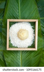 Chung Cake ingredients, tool preparation wrapping. Square shape wood mold with glutinous rice, split mung beans, chunks of pork shoulder, salt, pepper, ginger, bamboo, banana leaves, long node string.