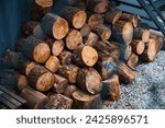 chunk pine log firewood stashed for cold winter ready for fire place or fire pit snow season