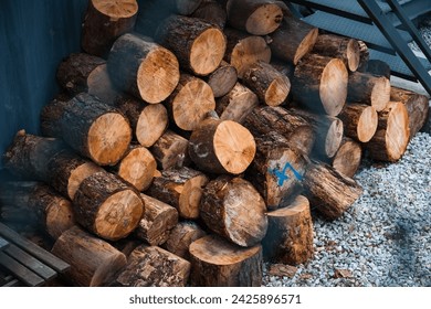 chunk pine log firewood stashed for cold winter ready for fire place or fire pit snow season