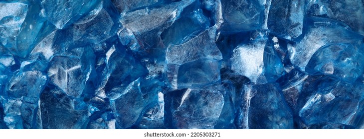 Chunks of clear glittering blue ice. Abstract cold or frozen winter background. - Shutterstock ID 2205303271