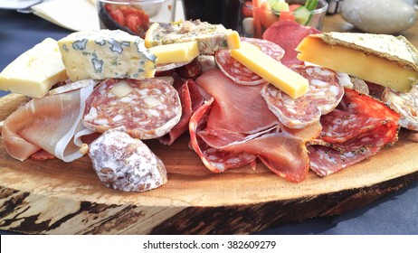 Chunks Of Gourmet Blue Cheese, Pork Ham, Liver Pate, Smoked Meats, Salami, Fat Sausages Served On Wood For Lunch In Apres Ski Bistro .