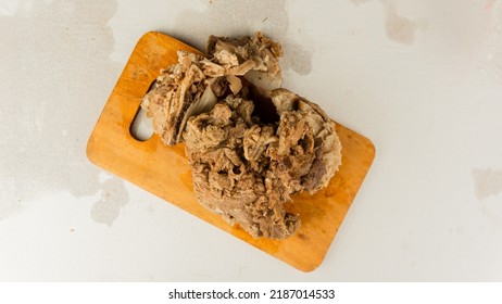 Chunks Of Half-cooked Beef Arranged On A Wooden Placemat