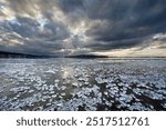 Chunks of ice lying on icy surface on the shore of Reichenau Island, Baden-Wuerttemberg, Germany, Europe