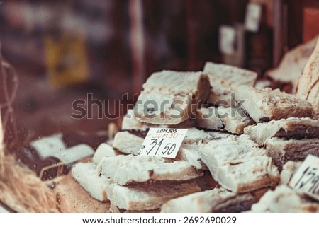 Chunks of salt cod are stacked, ready for sale. A price tag sits amongst them, offering this traditional Portuguese ingredient to eager customers in Porto