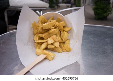 Chunky Tasty Cone of Chips on a table from British English Fish and Chip shop in England 