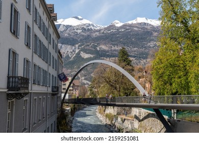 Chur, Switzerland, April 11, 2022 Modern Plessur Bridge With A Bow Over The Small River In The City Center