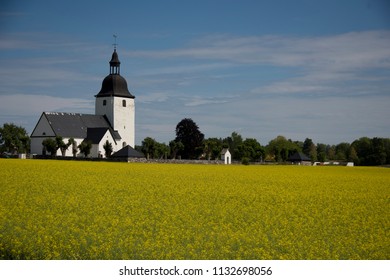 Färentuna Church From 1400s And A Rapeseed Field Dusted With Butterflies In Ekerö, Stockholm