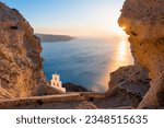 Church of Agios Nikolaos in Santorini island, Greece. Beautiful view of the sea and volcanic rocks at sunset. Famous travel destination