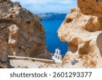 Church of Agios Nikolaos in Santorini island, Greece. Beautiful view of the sea and volcanic rocks at sunny day. Famous travel destination