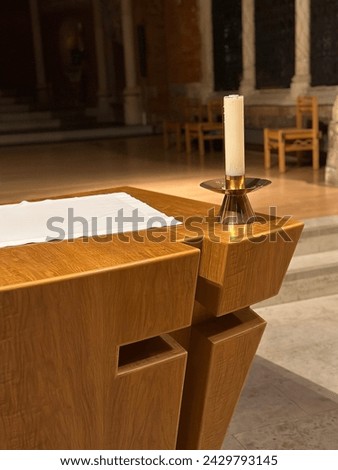 A church altar with a candle standing on it, in a Anglican Church in London, UK