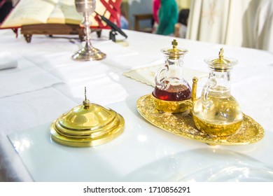 Church Altar With Small Wine Vial Ready To Become The Blood Of Jesus Christ During The Mass