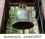 The church bell hangs on the bell tower. A beautiful, large bell made of bronze and copper, rings very loudly when the Holy Mass is held. Bell with inscriptions in Polish