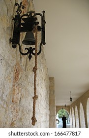 A Church Bell With A Monk Walking Away In The Background. Taken In Lebanon.