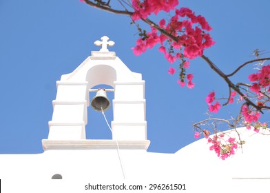 Church Bell And Pink Bougainvillea In Mykonos, Greece. Mykonos Is The Most Popular Greek Island, Known For Non-stop Party Island.