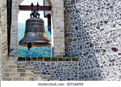 Church bell and rustic stone wall
