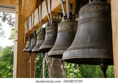 Church bells hang in a row, the bells are ringing. Church bell, several church bells in the monastery. Several metal church bells, bell ringing. - Powered by Shutterstock