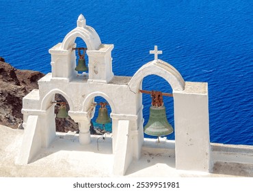 Church bells on the island of Santorini above the blue sea - Powered by Shutterstock