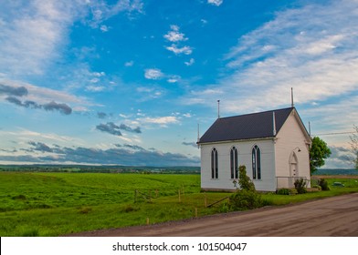 church building at sunset with orange glow from sun