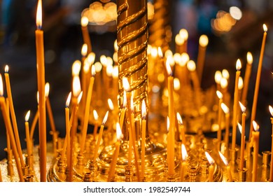 Church candles. Burning candles on a candlestick in an Orthodox church. A religious ritual.