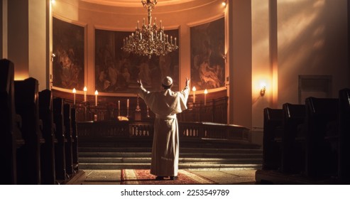 In Church Cathedral Pope Stands at Altar, and Raises his Hands Towards a Mural of Jesus Christ, Presenting Himself as a Devoted Servant of the Lord. Symbol Of Hope and Grace in Christian Faith - Shutterstock ID 2253549789