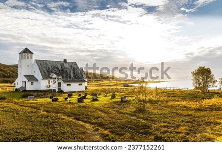 A church with a cemetery in a mountain village. Cemetery at wooden church. Church and cemetery. Rural church and cemetery