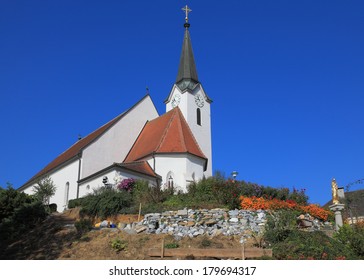 Church clearly look elegant against the clear blue sky. Church built on a hill and surrounded by flowers - Shutterstock ID 179694317