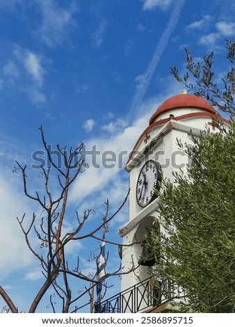 church clock and tree and blue sky
