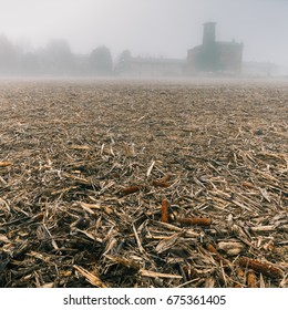 A church in the dense fog of the Lombardy region of Italy during the winter, frozen corn field - dystopian feel and look