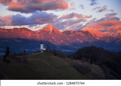 church in fresh frosty evening sun in winter mountains of the slovenian alps at sunset