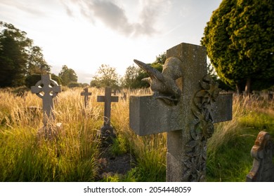 Church graveyard with gothic graves during golden hour in Derby, UK