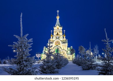 Church of the Holy Martyr Tatiana in Russia glows in the evening and the Christmas tree against the dark blue sky - Powered by Shutterstock