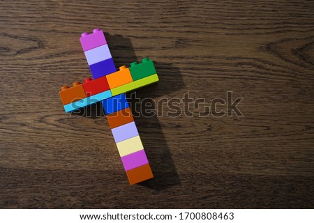 Church for kid concept, Bible Study for child, Colorful Christian cross made of bricks toys on wooden table.