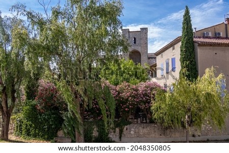 Church Notre Dame de Nazareth with floral garden in foreground, historical monument in Pernes les Fontaines, Provençal Romanesque architecture in Vaucluse, Provence, France, Europe