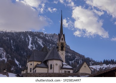 Church On A Hill In The Centre Of The City Of Moena In The Italian Dolomites In Valley Of Fassa On A Warm Winter Day.