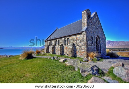 Church on a lake in New Zealand, against blue sky