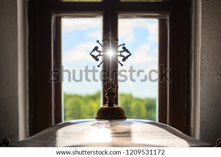 Church orthodox cross opposite window landscape sun rays blue sky green grass. Concept of Orthodoxy religion education enlightenment for protection of peaceful life of the clergy