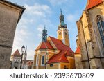 Church and other towers at the charming historical downtown of Kőszeg, Hungary - low angle street view
