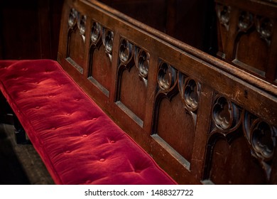 Church Pew With Red Velvet Cushion And Wooden Carvings