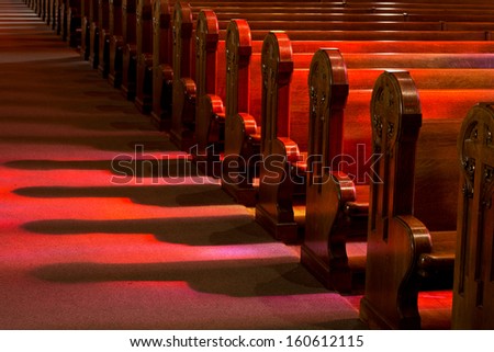 Church Pews in Reflected Stained Glass Lighting
