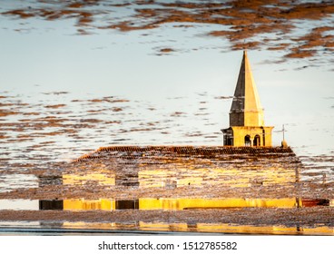 the church reflected in a puddle
