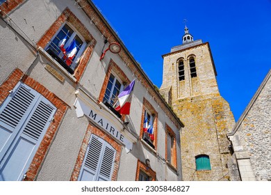 Church of Saint Genevieve overlooking the City Hall of the small village of Montigny Lencoup in the French department of Seine et Marne in the capital region of Ile de France near Paris