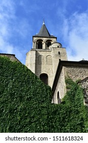 Church Of Saint Germain Des Pres. Bell Tower With Ivy And Blue Sky From The Boulevard Saint Germain. Paris, France.