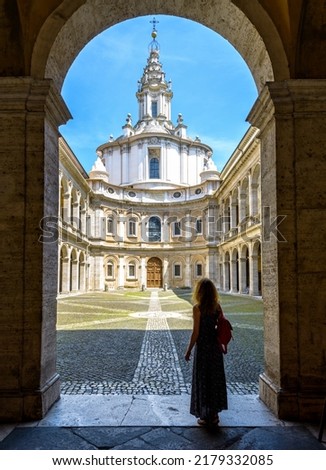 Church of Saint Yves at La Sapienza, Rome, Italy. Girl tourist visits former University of Rome. Person, young woman looks at city landmark. Concept of sightseeing, tourism and travel people in Rome.
