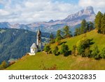 Church of Santa Barbara during the day in the cozy little village of La Valle, Alta Badia, South Tyrol  in Italy, Europe