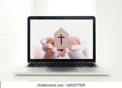 Church services online concept, Home church during quarantine coronavirus Covid-19, Online church from home new normal concept, Cross with hand pop up from screen laptop, spirituality and religion