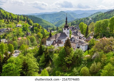 Church in The Spania Dolina village with surrounding landscape, Slovakia, Europe.