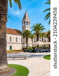 The Church of St Dominic, Trogir - Croatia. Beautiful view of ancient building, palm trees and the restaurant near. Summer weather.